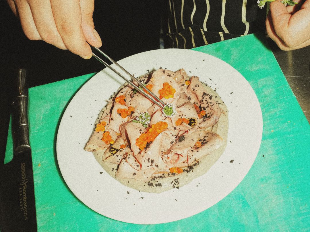 Chef plating roast beef